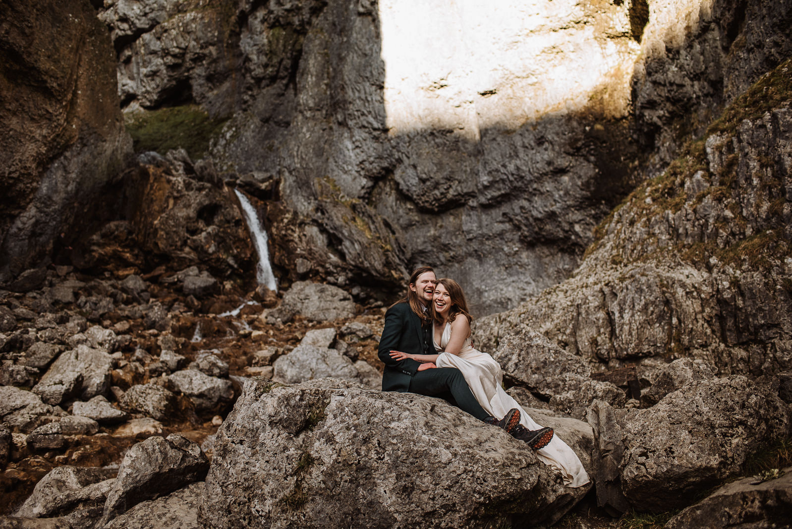 Couple sitting and cuddling, with waterfalls in the background
