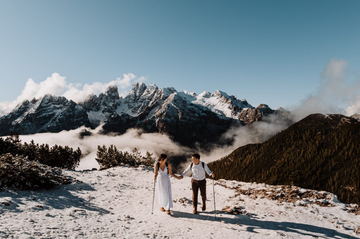 Couple hiking up with mountain in the background