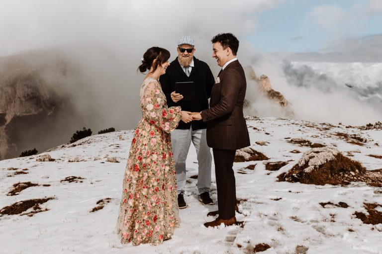 Couple exchanging rings on the top of a mountain