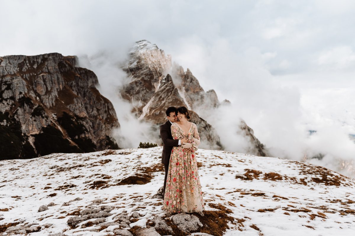 Couple cuddling in front of the mountain
