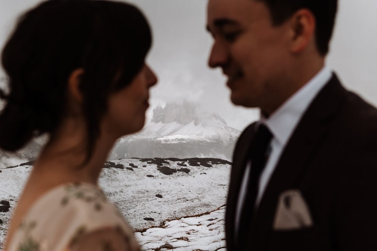 Couple looking at each other with mountain in the background