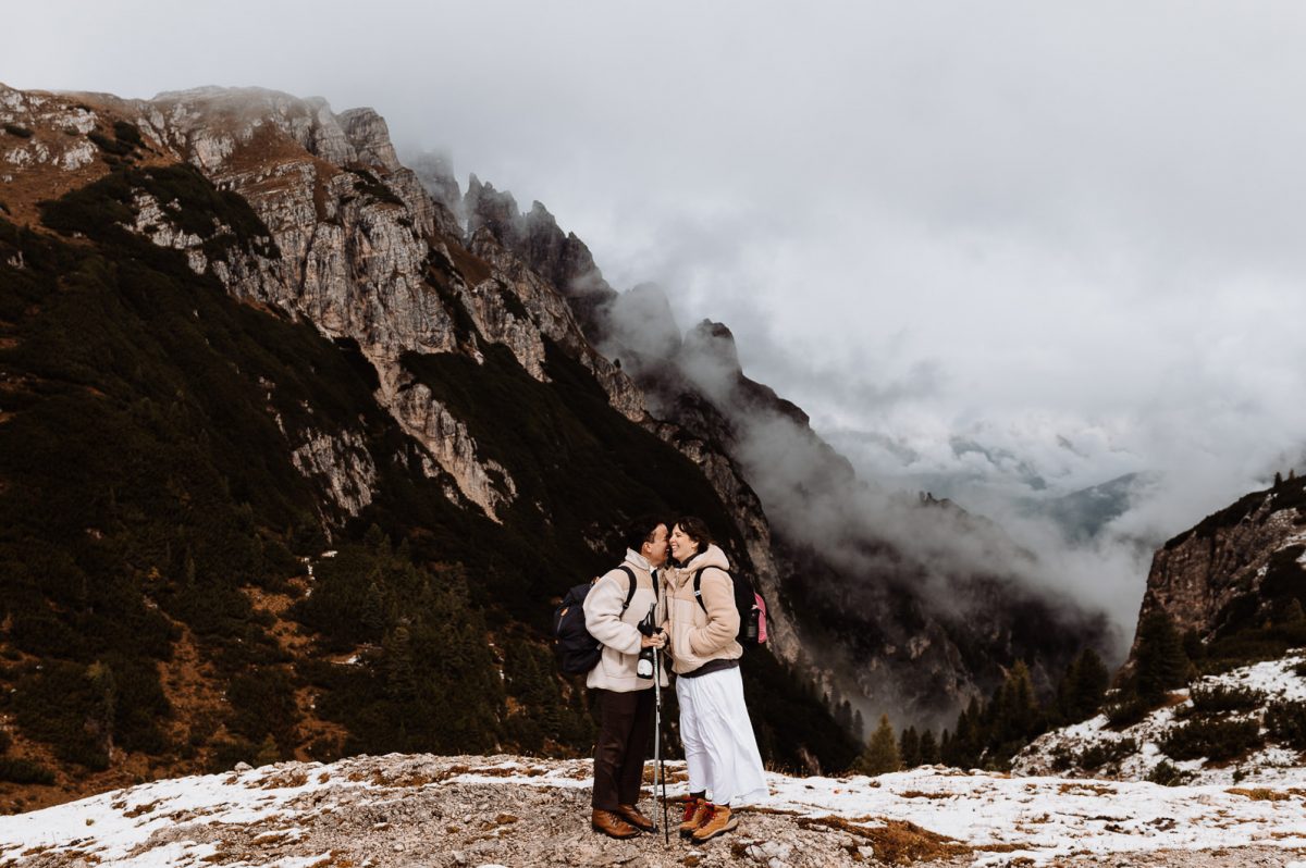 Couple kissing with mountain in the background