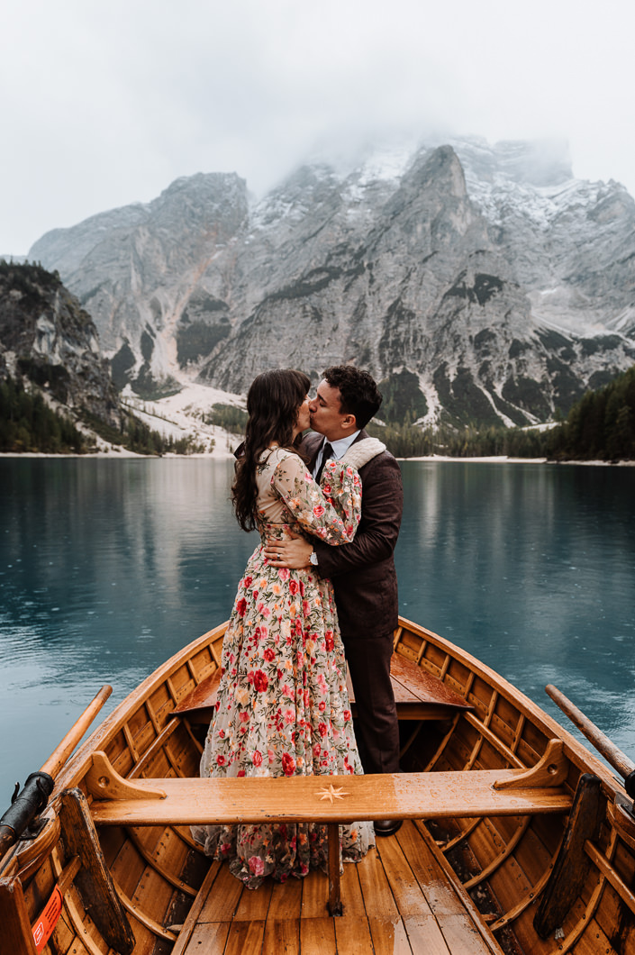 Couple kissing on a lake boat