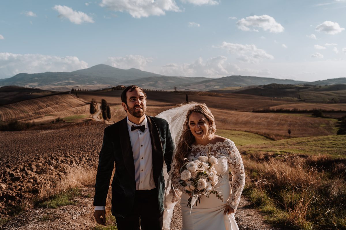 Couple walking on tuscan fields