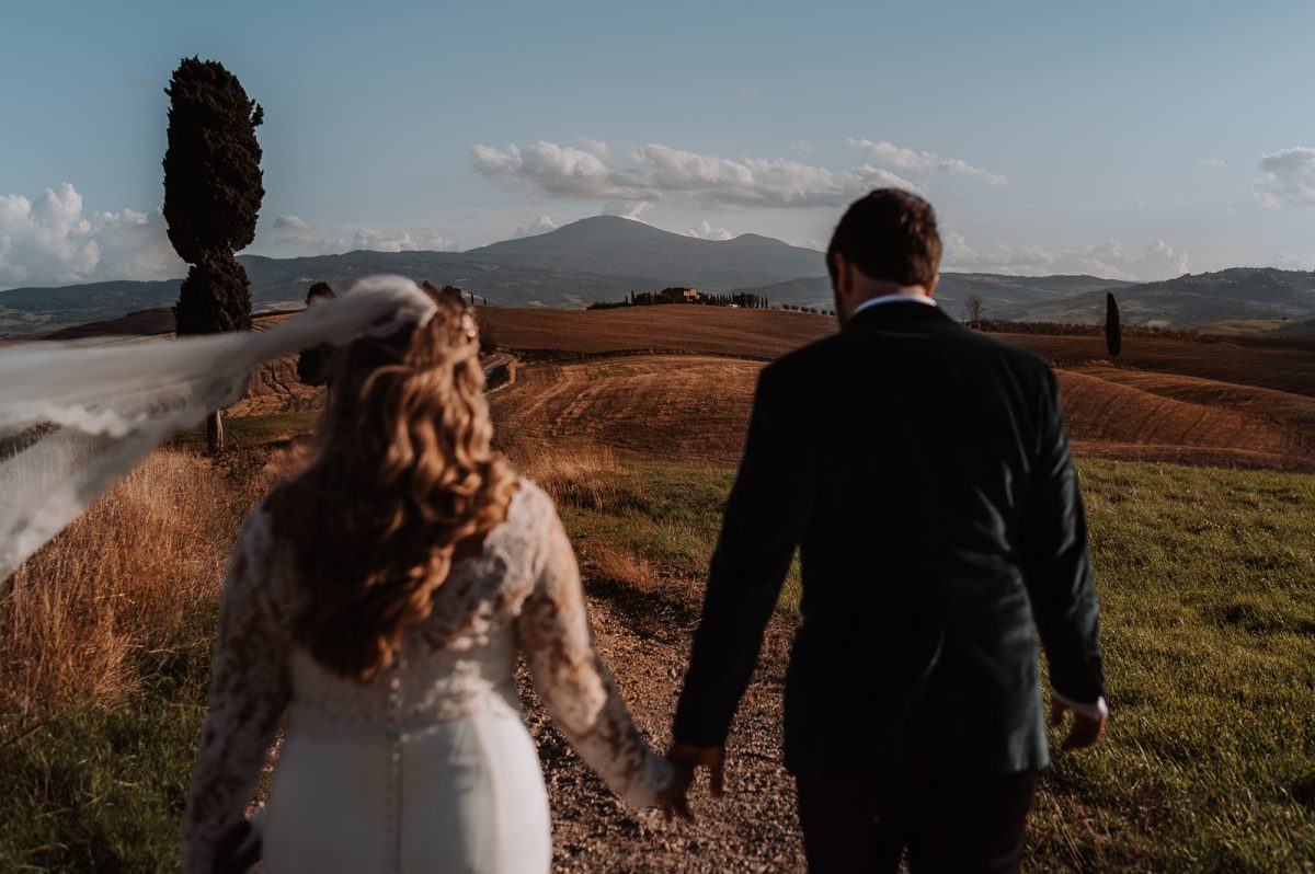 Couple walking and enjoying the view of Tuscan fields