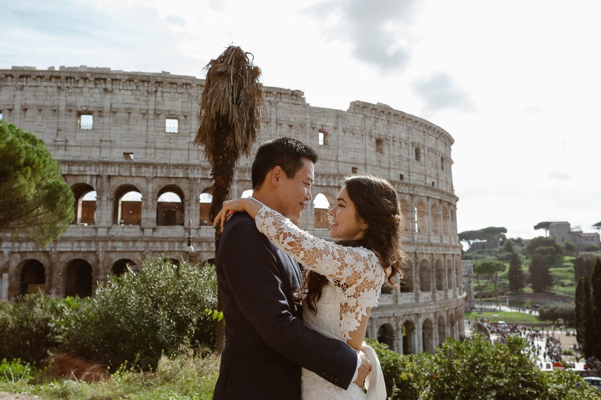 Couple standing in front of the Colosseum