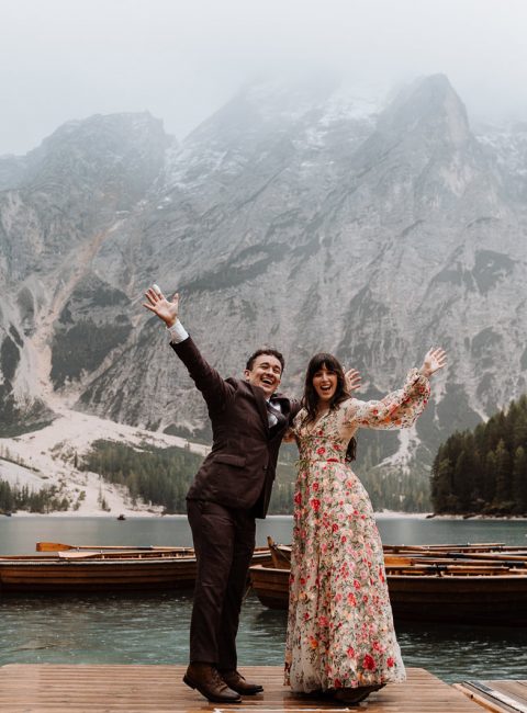 Couple celebrating their elopement at Braies Lake in Dolomites
